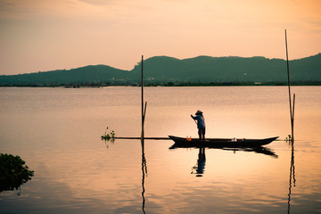 A fisherman cleaning up the lake in Indonesia 