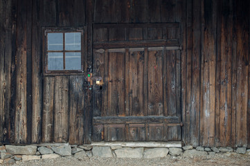 Rustic old peasant house with wooden windows