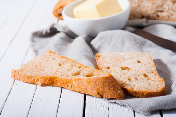 brown bread and butter, old knife on white wood table