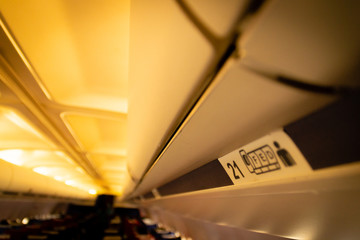 Seat numbers in an airplane on overhead compartment 