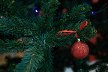Christmas decoration of green artificial Christmas tree with red balls