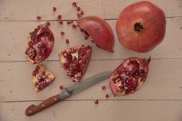 red pomegranate on wooden table