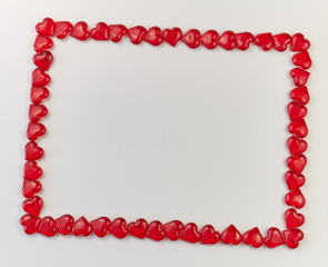 frame turned to the right for text made of red glass hearts on a white background. greeting card. Valentine's Day. Copy space