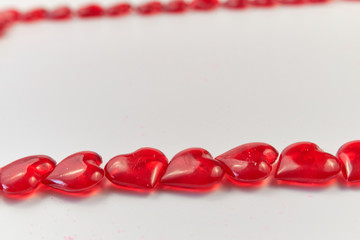 Two horizontal lines of small red hearts on a white background. Valentine's Day. love symbol. copy space. greeting card