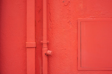 Red house facade with pipes in venetian district