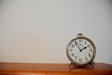 Classic vintage golden clock on a table with copyspace