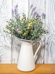 Colorful flowers in vase on table