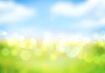 Fototapeta na wymiar Blue sky green grass blurred bokeh background.