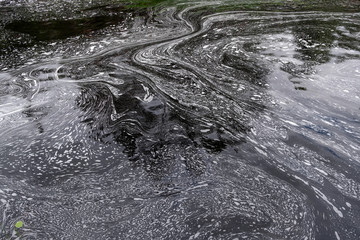 Foam patterns on the water surface.