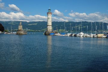 a large monument as entrance to the harbor of lindau on lake constance