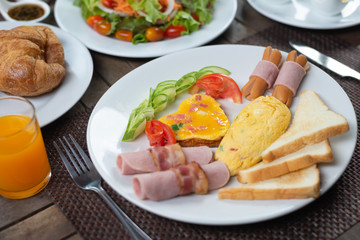 Fototapeta na wymiar Food series: American breakfast set on wooden table