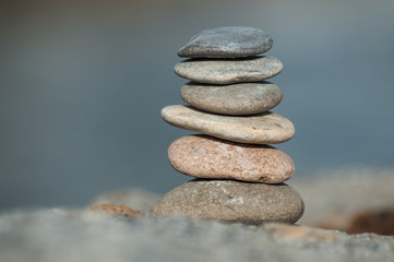 Closeup of stone balance on rock in border river