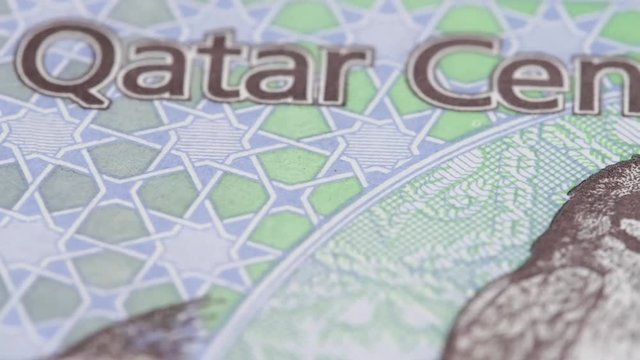 Qatar riyals macro slow rotating. Low angle. Stock video footage.