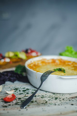 Baked zucchini and cheese soufle with italian bruschetta and herbs