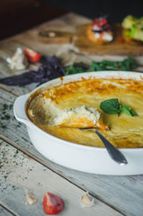 Baked zucchini and cheese soufle with garlic and herbs