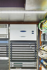 Photo of the wall with the timecode generator in the server rack in the front and video mixer for...