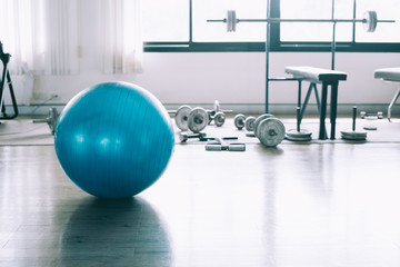 Exercise blue color ball in fitness, gym equipment in sports club.