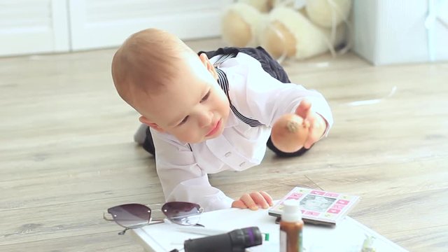 Little baby man in costume is played on the floor