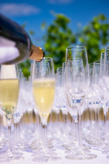 Pouring champagne, sparkling wine into glasses