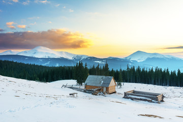 Evening in the mountainous valleys in the Ukrainian Carpathians with a beautiful sky and overlooking the snow-capped peaks.