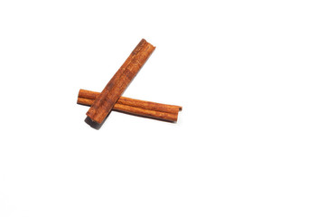 Cinnamon sticks lie cross on a white background, a popular aromatic spice used in cooking, in desserts, in seasonings and blends for mulled wine.