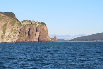 Fototapeta na wymiar View of the coastal cliffs of the Kamchatka Peninsula, Russia. The Kamchatka peninsula contains the volcanoes of Kamchatka, a UNESCO World Heritage Site.