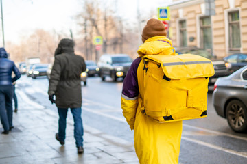 courier delievery guy with huge backpack on foot b