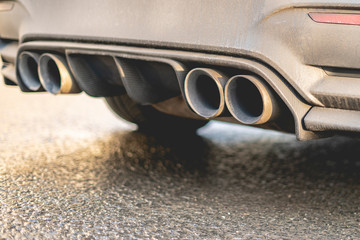 close up exaust pipe of a car releasing gas b