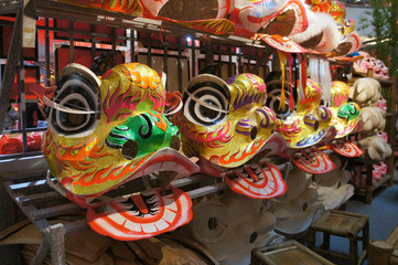 Chinese tradition lion mask or lion head displayed on rack. It is used to performed lion dance during Chinese New Year Festival.   