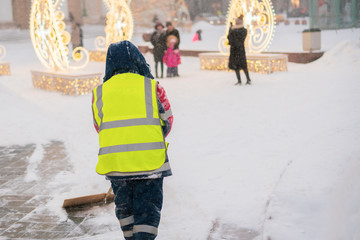 city service guy clean snow from streets with shovel а © Mihail