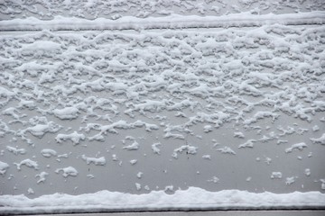 Textured background. Gray steel wall with the snow. snow texture on the surface