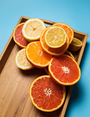 cut in half juicy citruses on a blue background on a tray