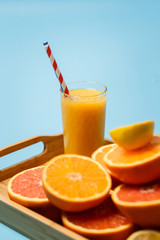 cut in half juicy citruses on a blue background