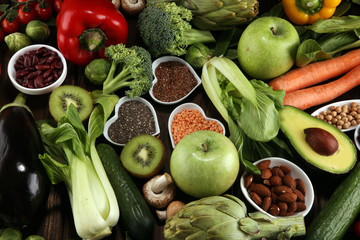 Healthy food clean eating selection. fruit, vegetable, seeds, superfood, cereals, leaf vegetable on rustic background