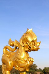 Golden Thai lion statue in Singha Park, Chiang Rai, Thailand - 247025212