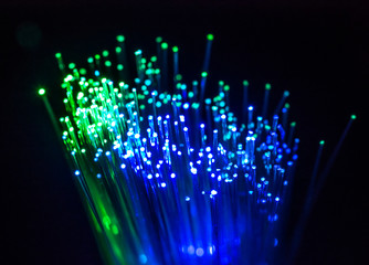 Colourful optic fibers illuminated on dark background. High speed internet concept. Data transfer...