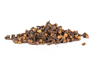 Lot of whole small dried cloves spice heap isolated on white background