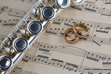 Wedding rings with Flute on old notes background for graphic and web design, Modern background. Internet concept. Trendy background for website design or mobile app
