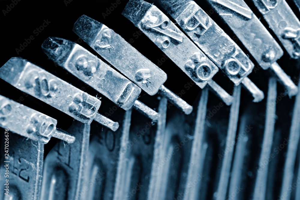 Fototapete detail of the individual hammers with engraved text and typescript inside vintage mechanical typewri