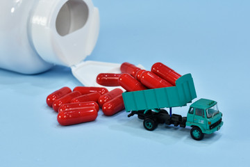 Capsules from ginger. Truck carrying some capsules. transportation of health. healthy load. Dietary pills supplements with good truck transportation.