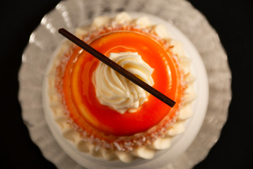 new, unusual cake on a black background, top view