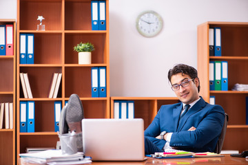 Fototapeta premium Young handsome businessman working in the office
