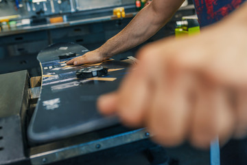 Maintenance of Snowboard. Specialist in Snowboard, repairing a Snowboard in his workshop