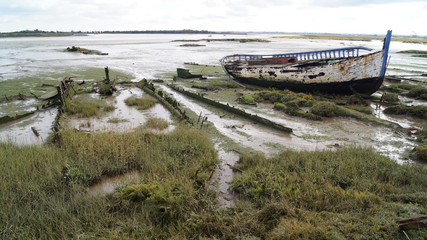 derelict boat on mud flat