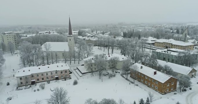 Aerial view of the city at cold winter morning. Sunrise in foggy day.  Aerial view of the frozen town at cold winter day. 
