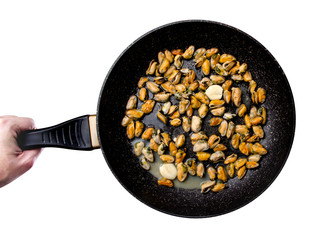 Pan with mussels with garlic in hand on a white background. Isolation