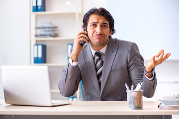 Young handsome businessman employee in the office