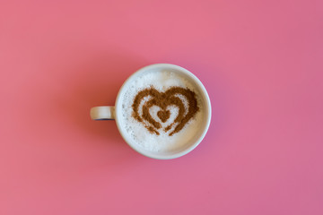 Heart Shape Coffee Cup Concept isolated on pink background. love cup , heart drawing on latte art coffee.
