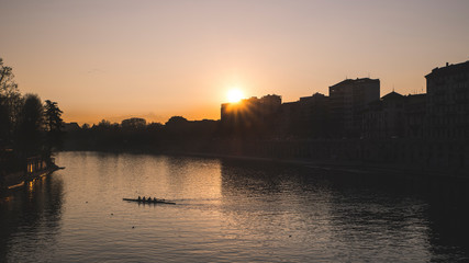 Fototapeta na wymiar Sunset on the river Po in the city of Turin with rowing boat.