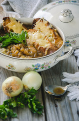 Homemade French Onion Soup with Cheese and Toast on a wooden background